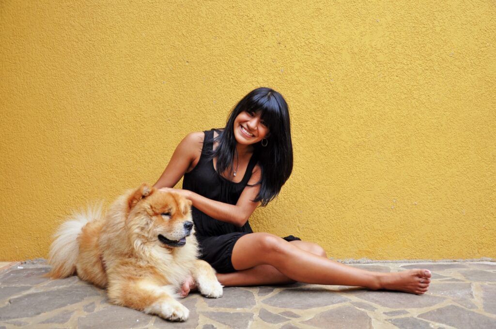 Australian dog owner smiling with her dog at a park
