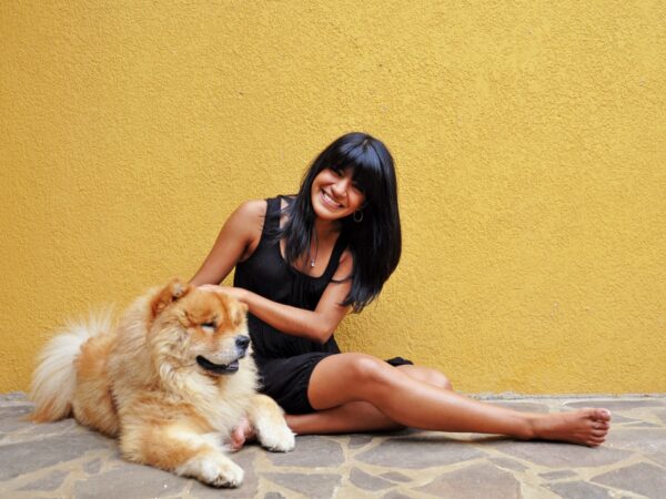 Australian dog owner smiling with her dog at a park