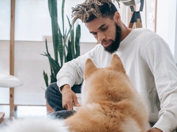 Pet owner relaxing indoors with a fluffy dog during winter