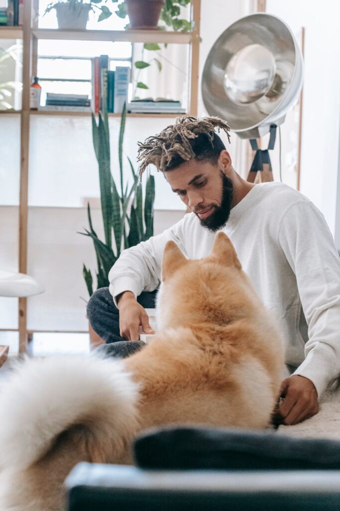 Pet owner relaxing indoors with a fluffy dog during winter